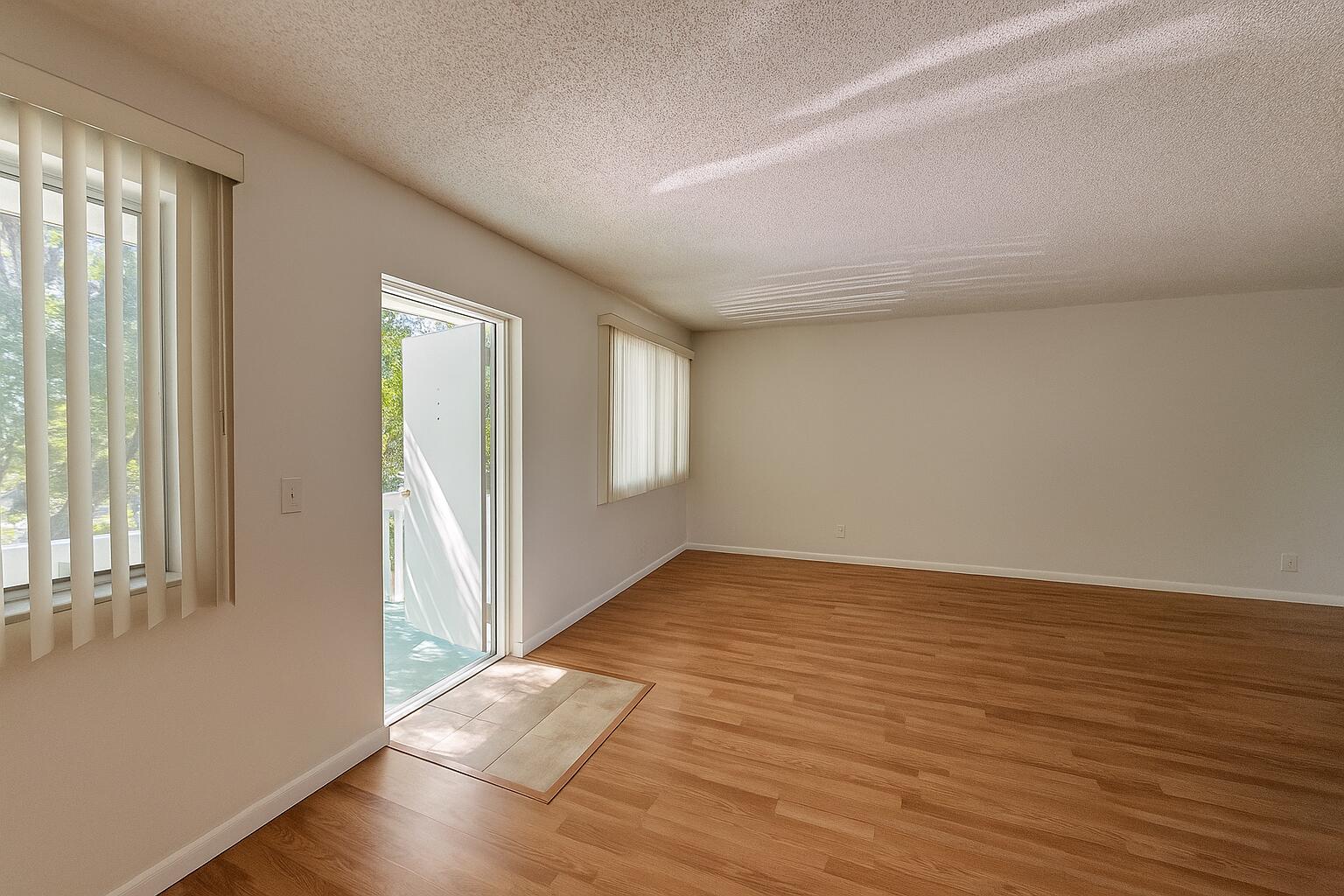 3000 Springdale Boulevard, Unit V303 Palm Springs, FL 33461 - Photo 8 of 22 a view of an empty room with wooden floor and a window