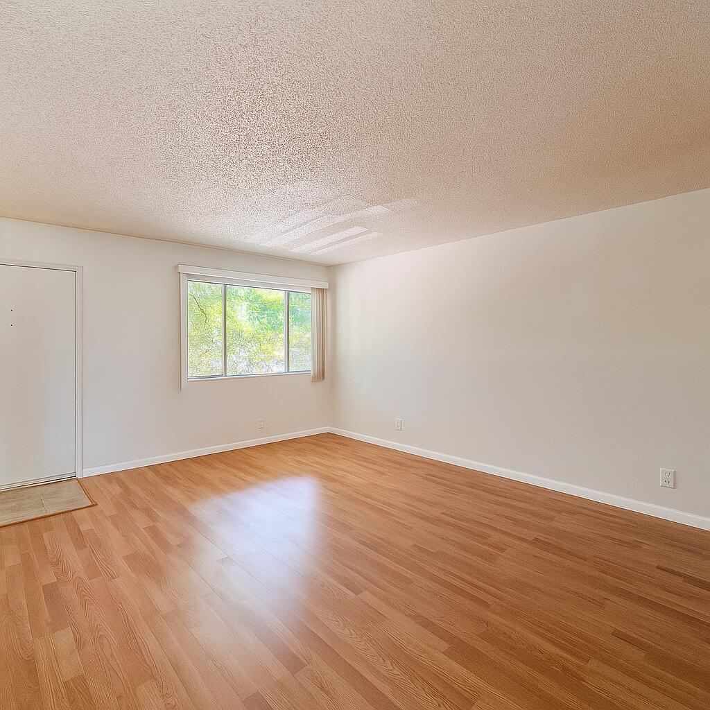 3000 Springdale Boulevard, Unit V303 Palm Springs, FL 33461 - Photo 9 of 22 an empty room with wooden floor and windows