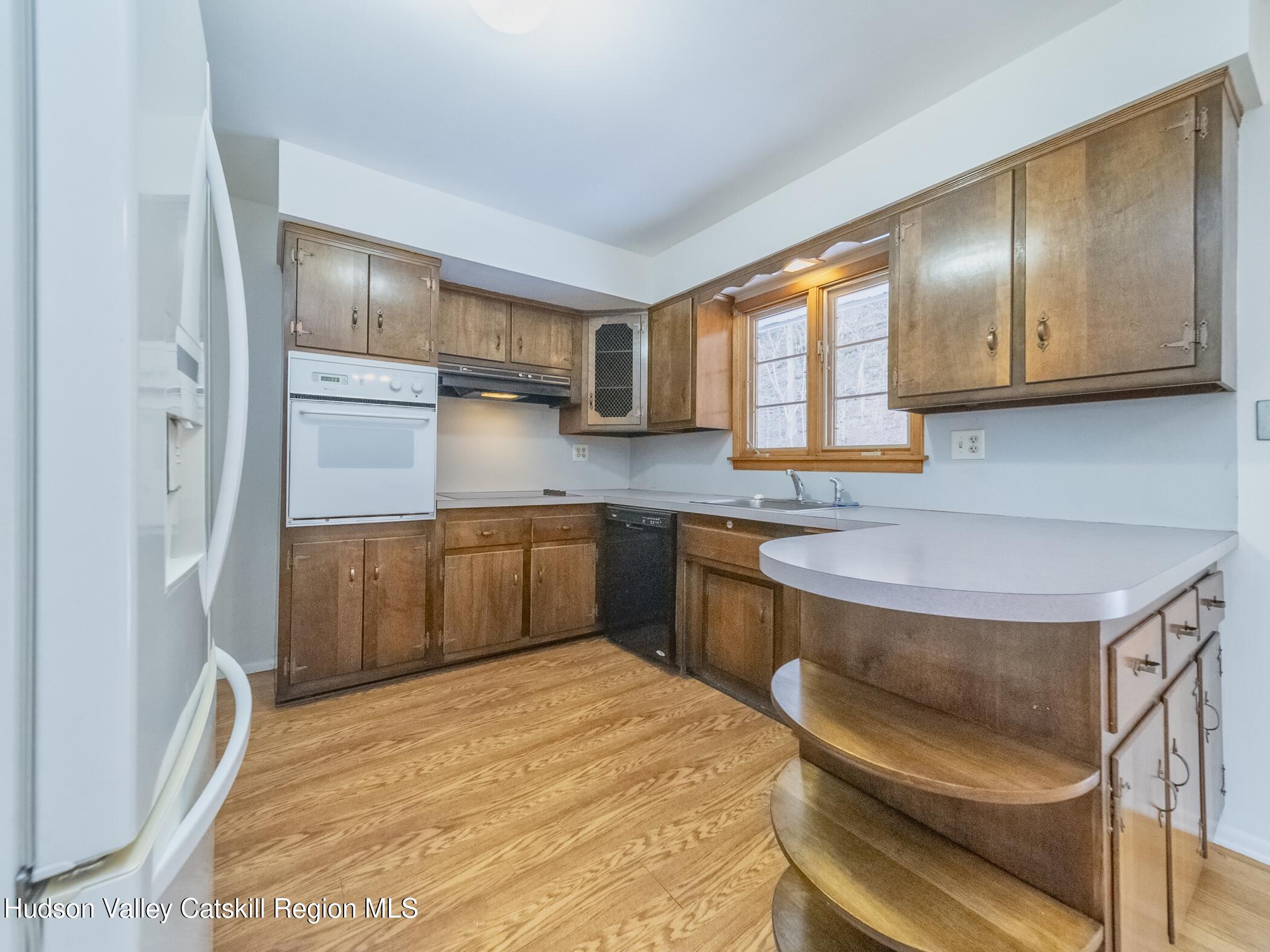30 Redwood Road Saugerties, NY 12477 - Photo 12 of 31 a kitchen with a refrigerator sink and cabinets