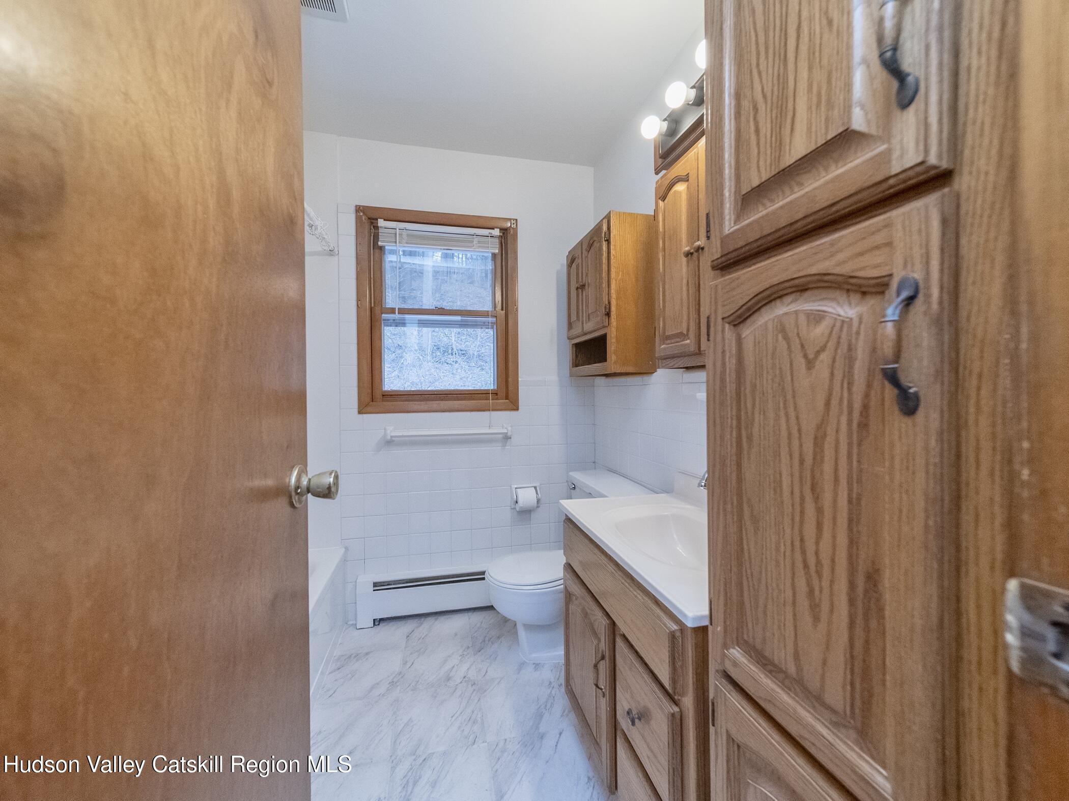 30 Redwood Road Saugerties, NY 12477 - Photo 18 of 31 a bathroom with a sink a toilet and shower