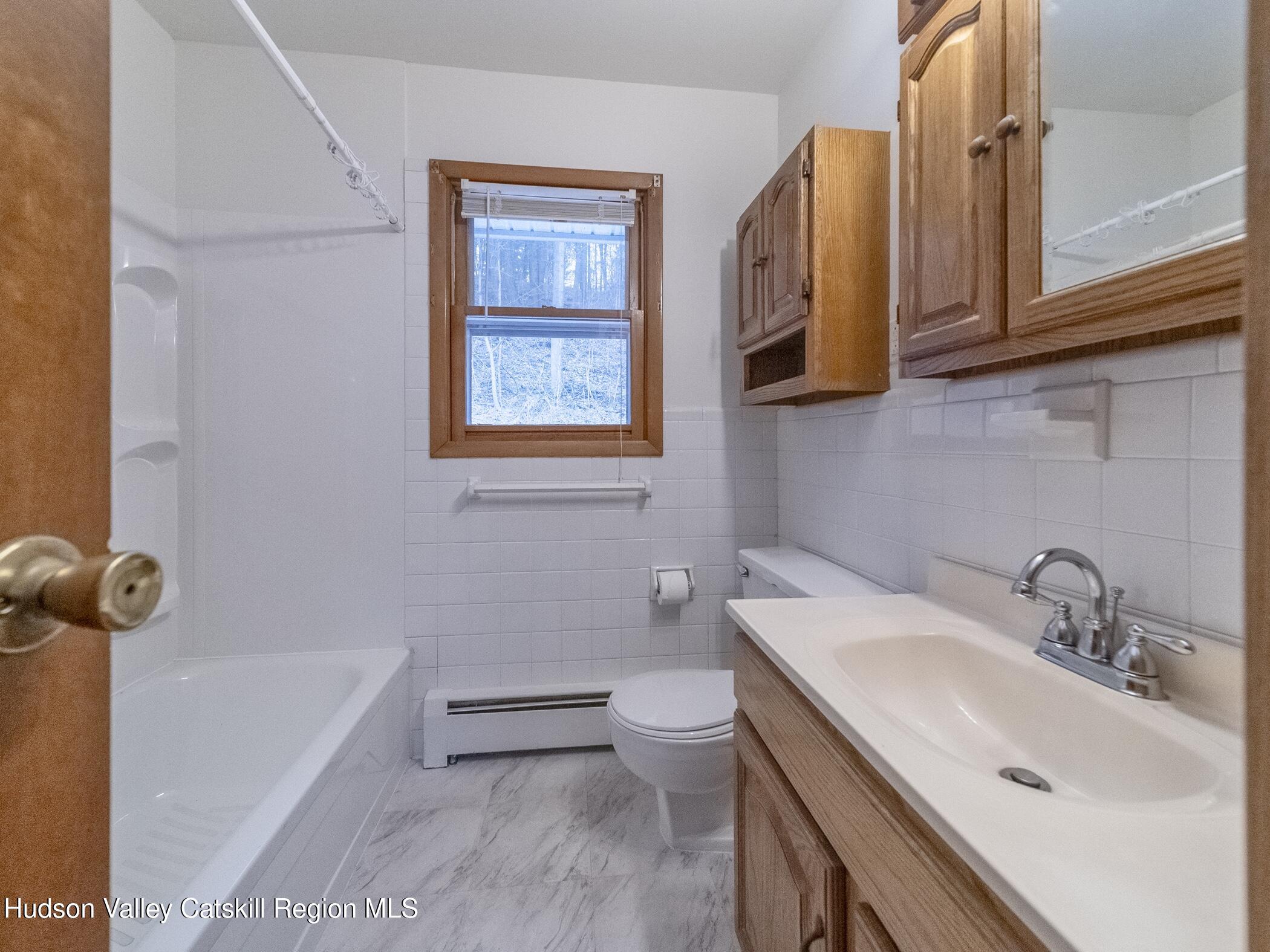 30 Redwood Road Saugerties, NY 12477 - Photo 19 of 31 a bathroom with a sink a toilet and shower