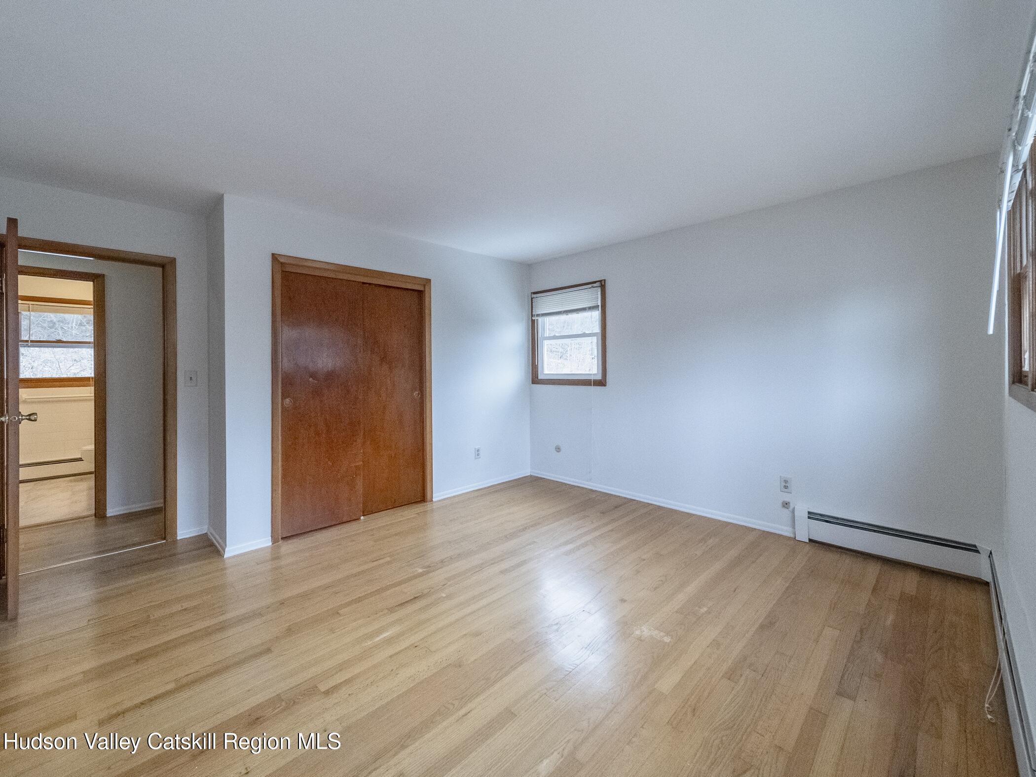 30 Redwood Road Saugerties, NY 12477 - Photo 23 of 31 an empty room with wooden floor and windows