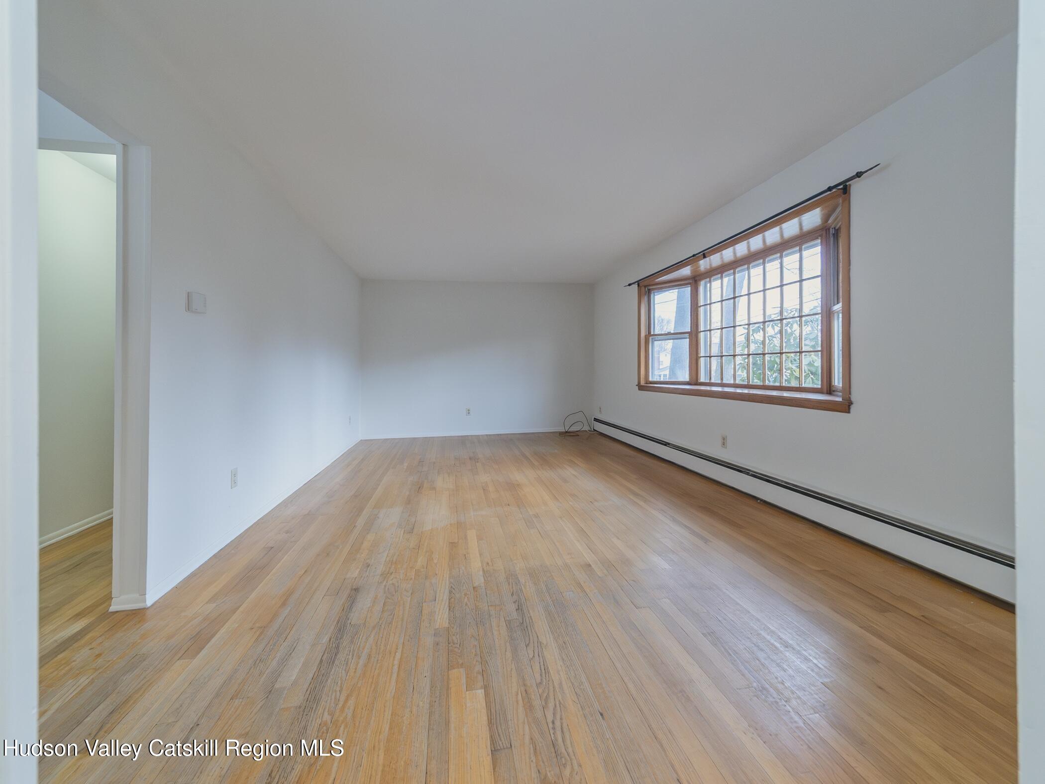 30 Redwood Road Saugerties, NY 12477 - Photo 3 of 31 an empty room with wooden floor and windows