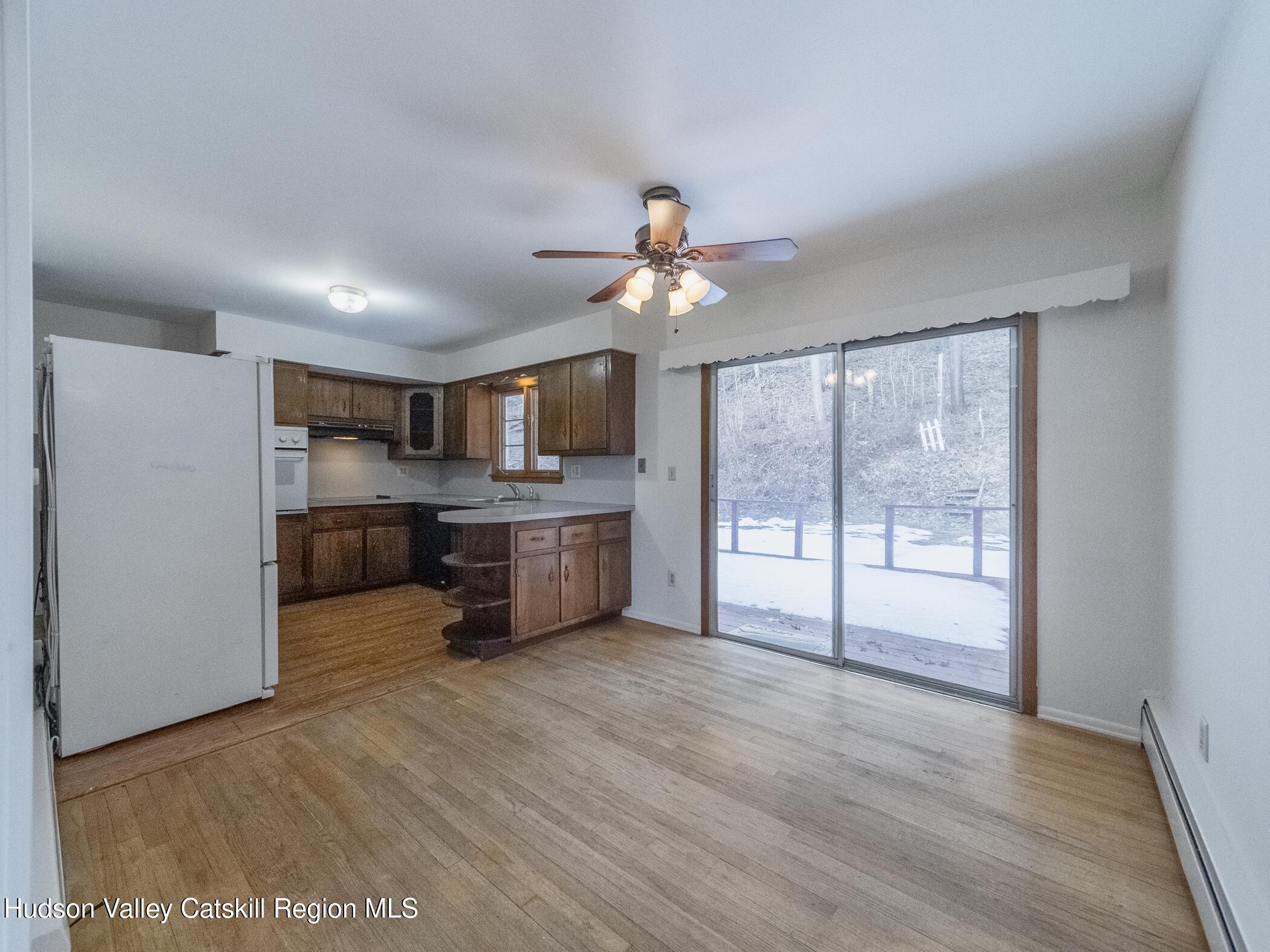 30 Redwood Road Saugerties, NY 12477 - Photo 8 of 31 a living room with stainless steel appliances kitchen island granite countertop a stove top oven a sink with cabinets and wooden floor