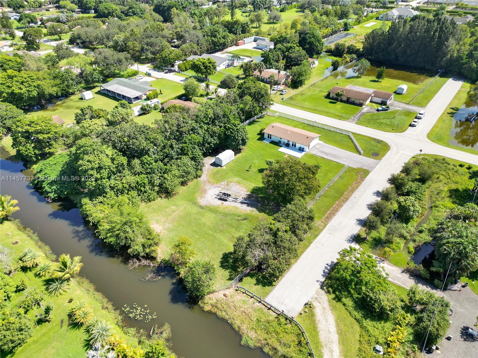 5891 Southwest 188th Avenue Southwest Ranches, FL 33332 - Photo 3 of 12 a picture of a yard with plants and lake view