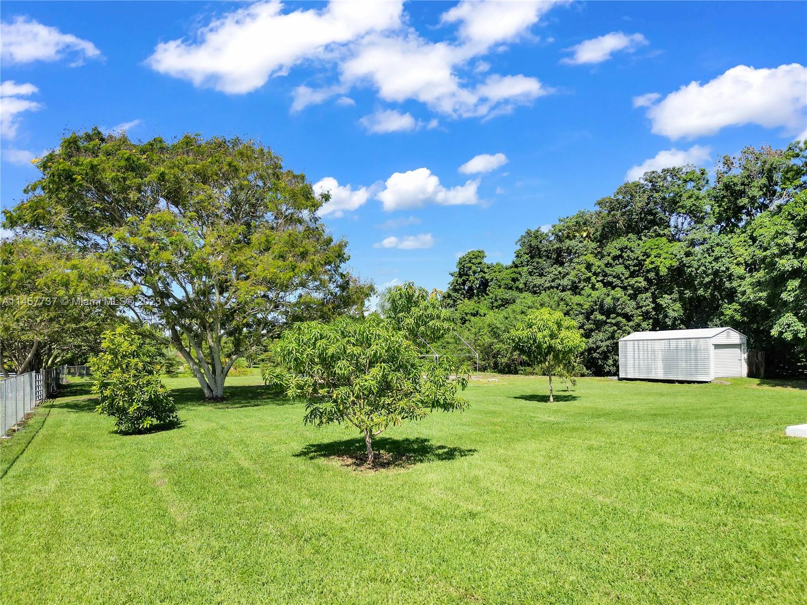 5891 Southwest 188th Avenue Southwest Ranches, FL 33332 - Photo 4 of 12 a backyard of a house with table and chairs