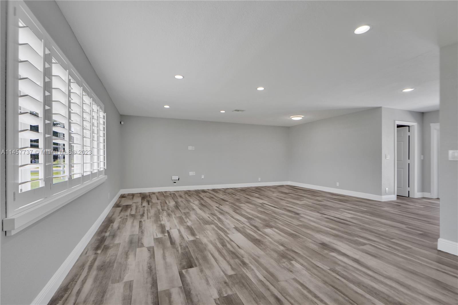 5891 Southwest 188th Avenue Southwest Ranches, FL 33332 - Photo 5 of 12 a view of an empty room with wooden floor and a window
