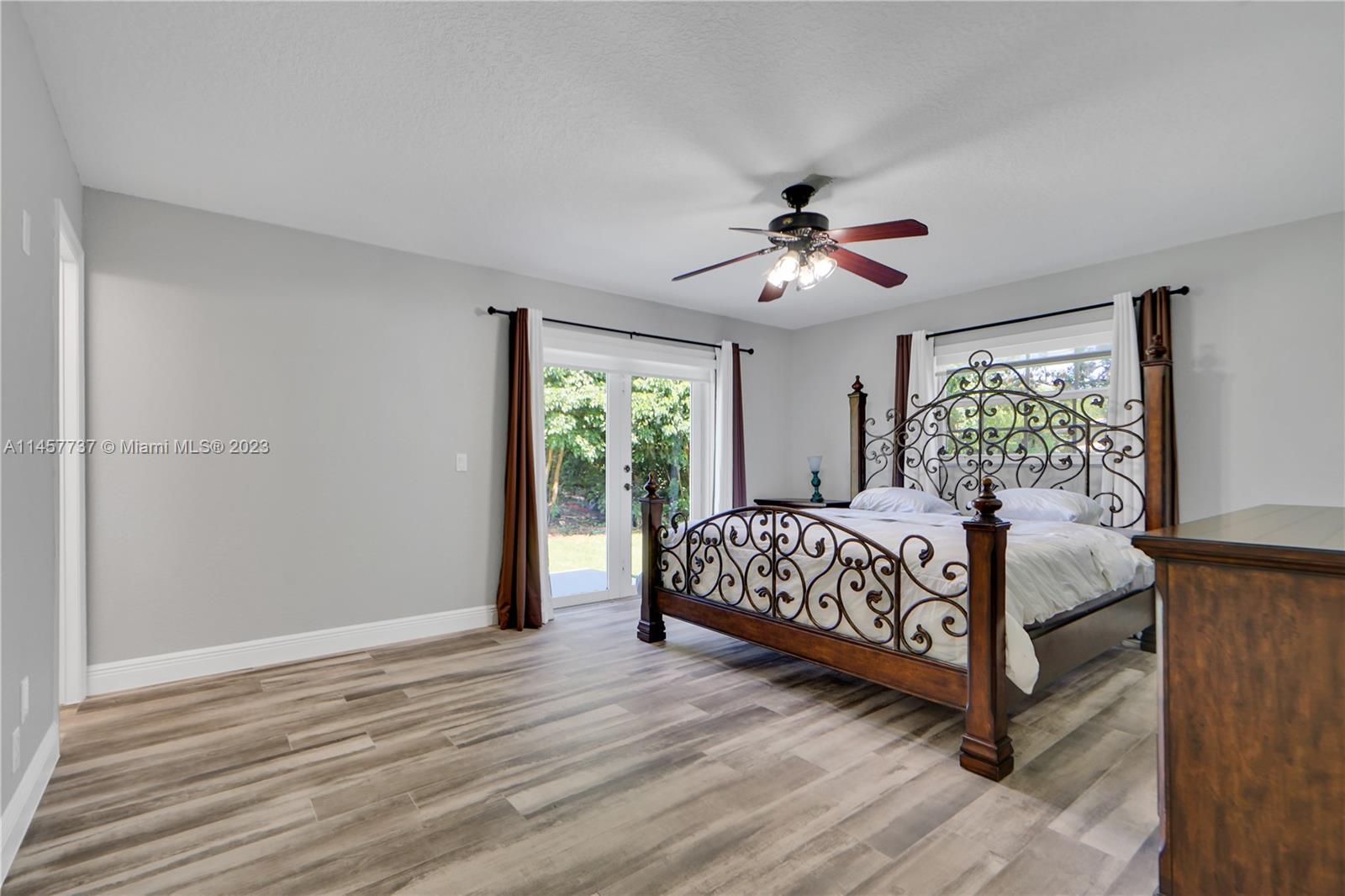 5891 Southwest 188th Avenue Southwest Ranches, FL 33332 - Photo 9 of 12 a bed sitting in a spacious bedroom next to a window