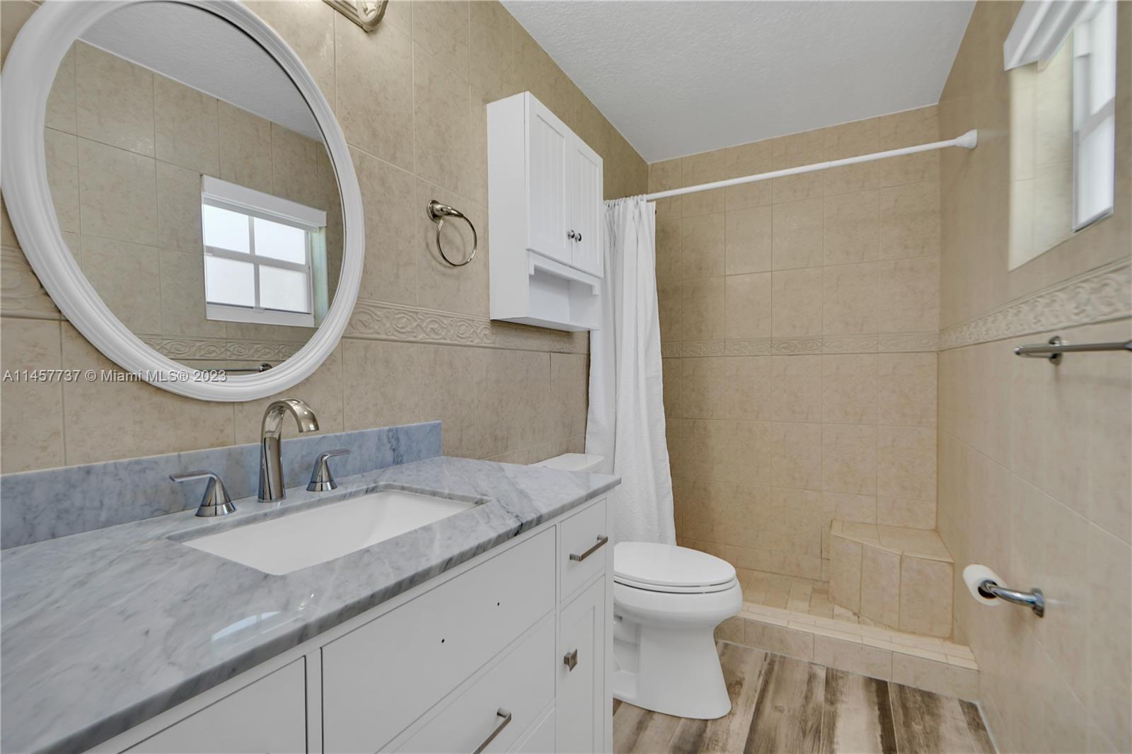 5891 Southwest 188th Avenue Southwest Ranches, FL 33332 - Photo 10 of 12 a bathroom with a granite countertop sink toilet and shower