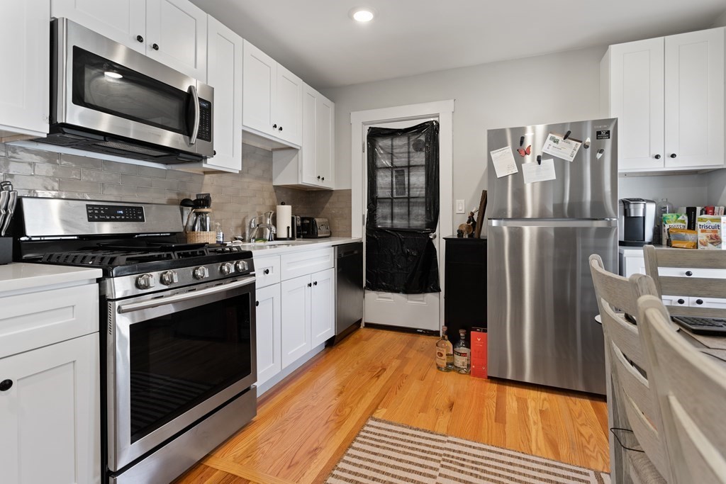 a kitchen with stainless steel appliances a stove microwave and a refrigerator