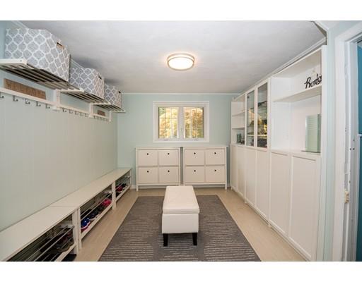18 Austin Road Sudbury, MA 01776 - Photo 23 of 38 a hallway with a large white bed and cabinets