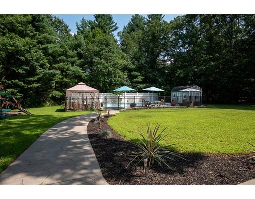 18 Austin Road Sudbury, MA 01776 - Photo 33 of 38 a view of a swimming pool with lawn chairs under an umbrella