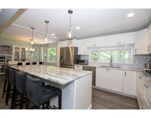 18 Austin Road Sudbury, MA 01776 - Photo 7 of 38 a kitchen with kitchen island granite countertop a sink cabinets and stainless steel appliances