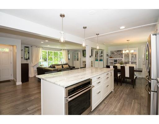 18 Austin Road Sudbury, MA 01776 - Photo 10 of 38 a kitchen with stainless steel appliances kitchen island granite countertop a stove a sink a refrigerator and white cabinets with wooden floor