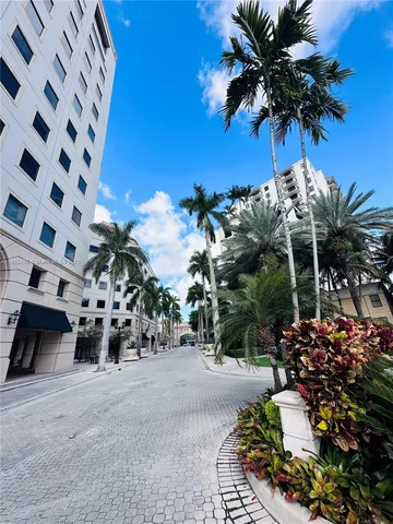 a view of a street with potted plants