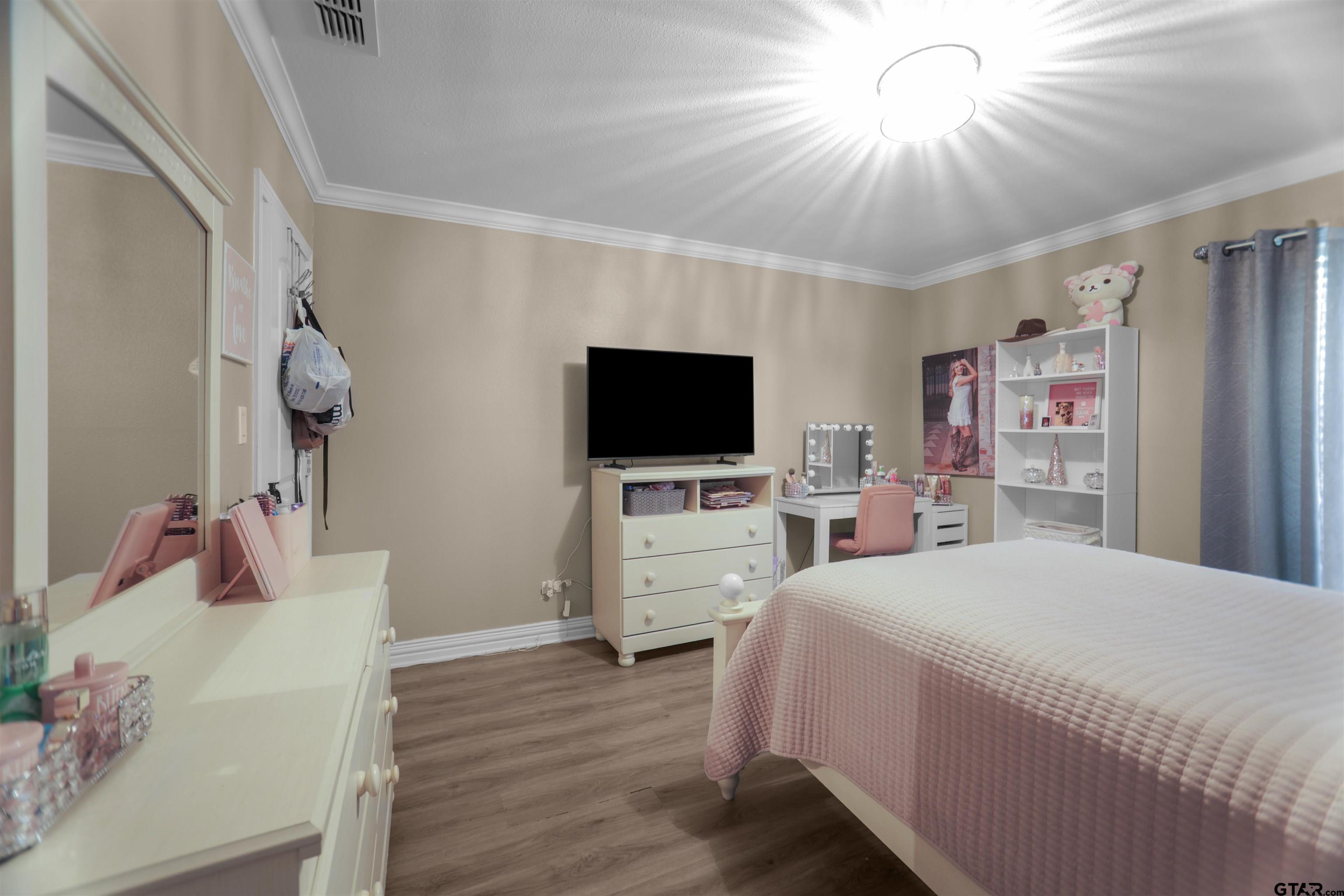 11931 State Highway 64 Tyler, TX 75704 - Photo 21 of 44 a bedroom with a bed and a flat screen tv