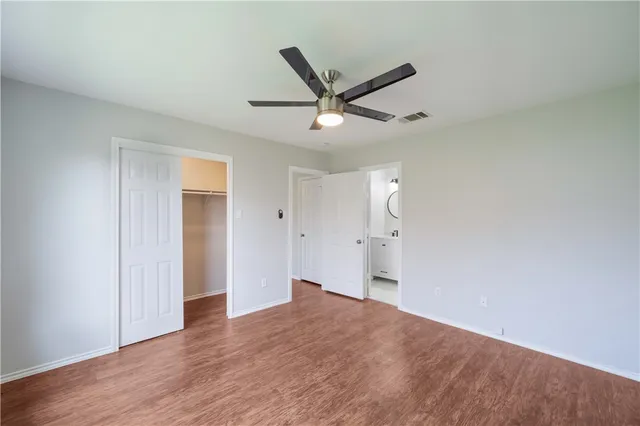 a big room with wooden floor and windows