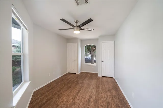 a view of a livingroom with wooden floor and a window