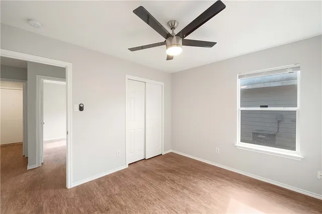 a view of a livingroom with a ceiling fan and window