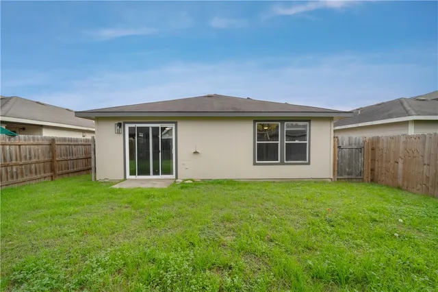 a view of a house with backyard and garden