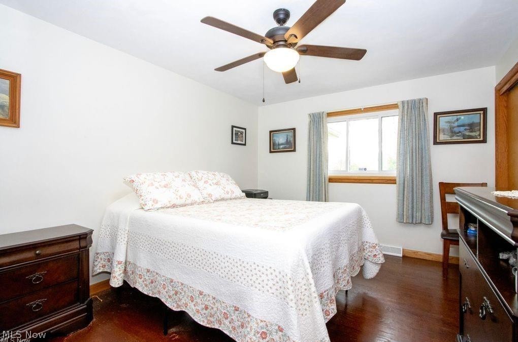 2530 Tuckahoe Road Wooster, OH 44691 - Photo 23 of 29 Bright room featuring wood-finish flooring, a ceiling fan with integrated lighting, and a window with a wood-trimmed frame