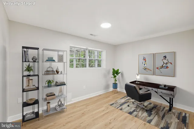 a bathroom with a granite countertop toilet sink and mirror