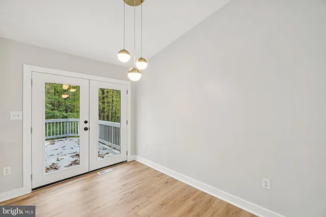 a view of a room with wooden floor and window