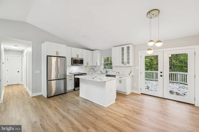 a kitchen with stainless steel appliances a sink stove and refrigerator