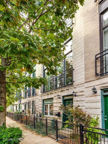 a front view of a house with a tree