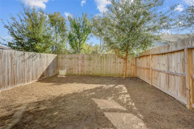 a backyard of a house with a tree