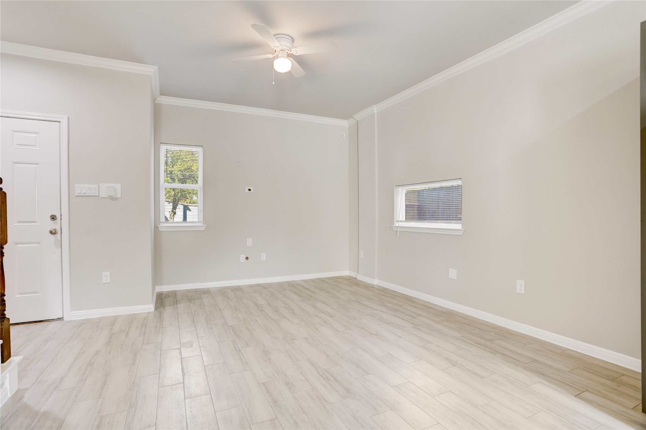 1045 Marcolin Street Houston, TX 77088 - Photo 5 of 16 an empty room with wooden floor and windows