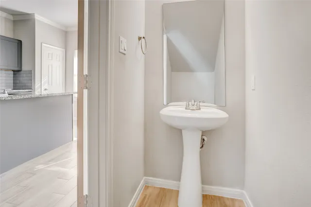 a bathroom with a sink a mirror and a window