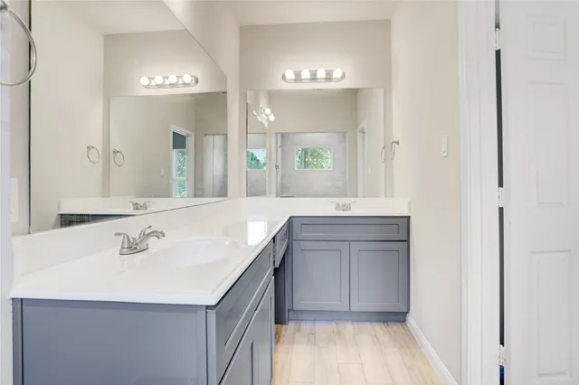 a bathroom with a sink vanity and a mirror