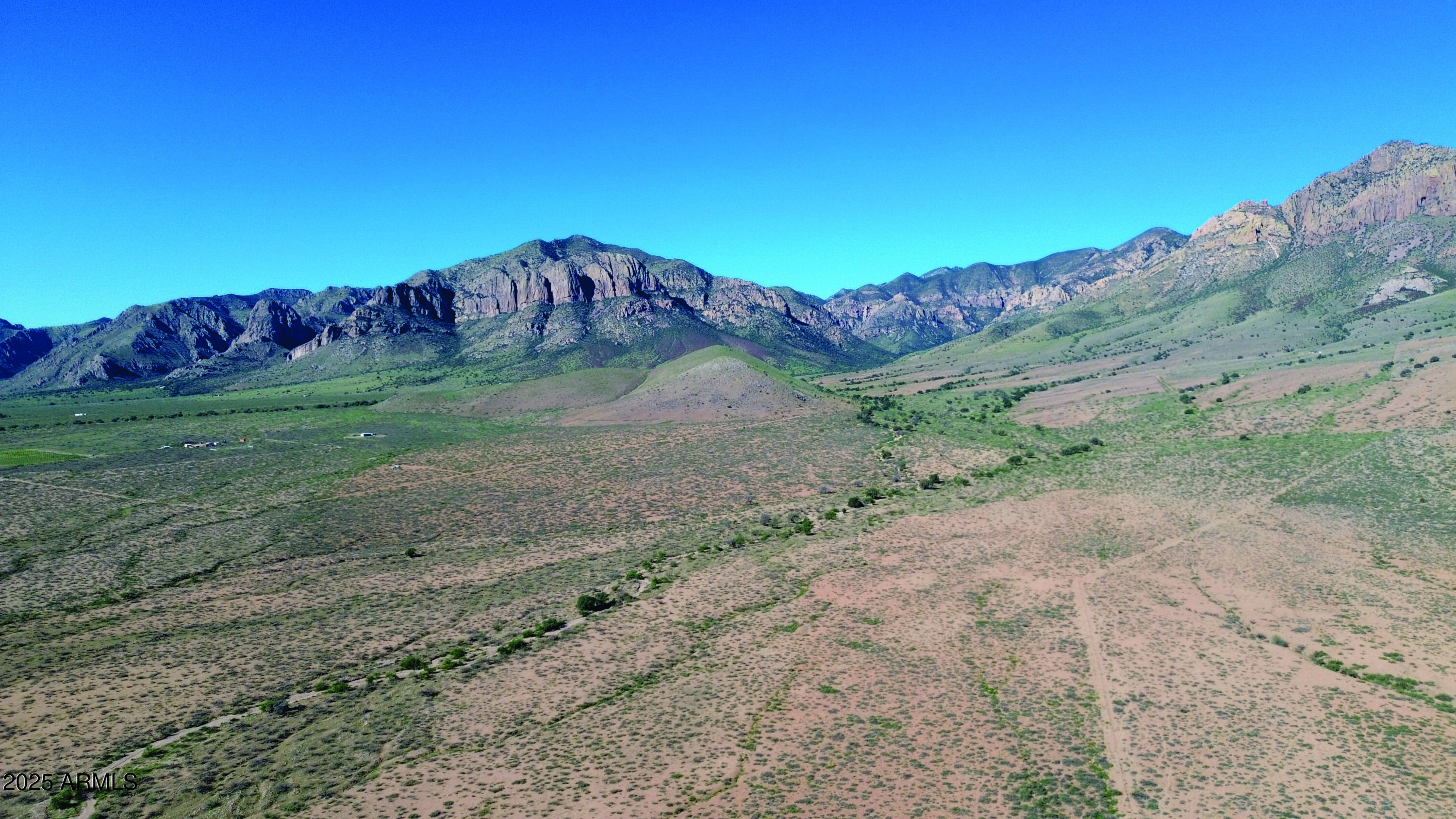 a view of a dry yard with mountain