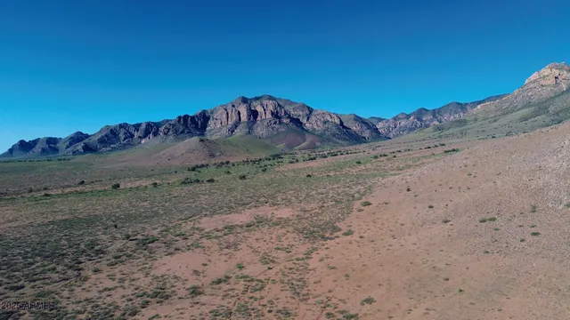 a view of a dry area with wooden fence