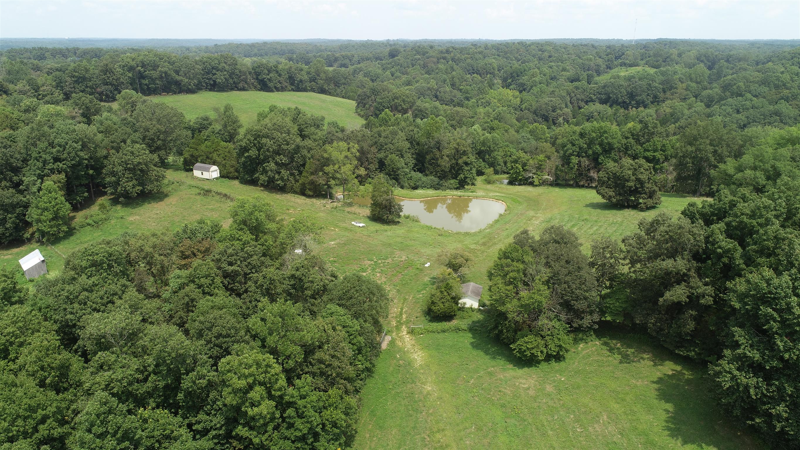 300 Moore Road Dickson, TN 37055 - Photo 1 of 21 a view of a green yard with large trees