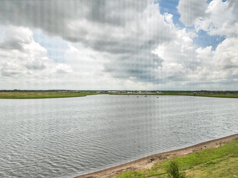 19116 Scallop Loop, Unit 303 Lakewood Ranch, FL 34211 - Photo 32 of 32 a view of a lake from a yard