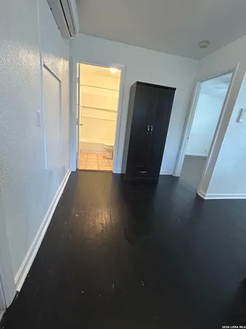 a view of a livingroom with wooden floor and a window