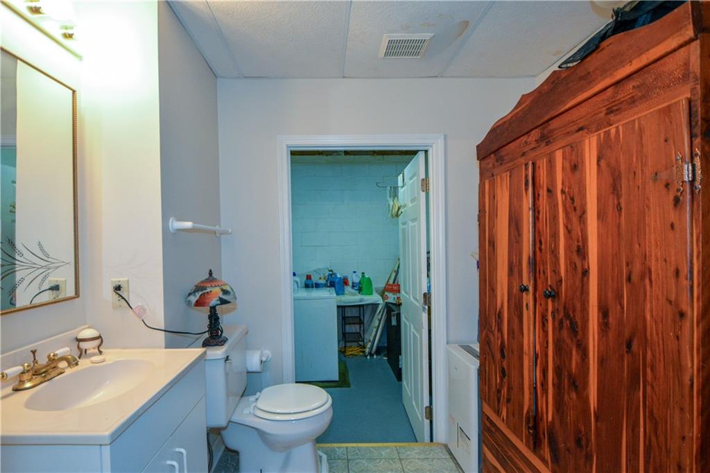 130 Hawn Road Fayetteville, GA 30215 - Photo 30 of 67 a bathroom with a sink a toilet and shower curtain