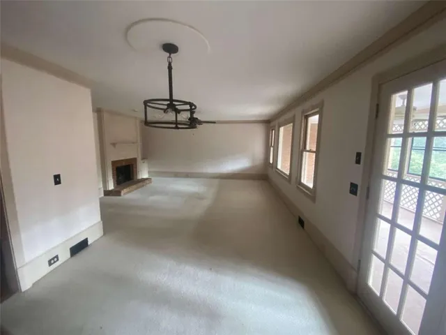 a view of a big room with windows and chandelier