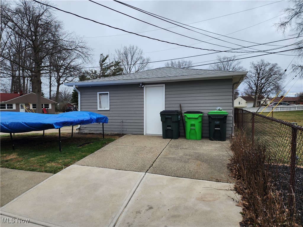 667 Sterling Road Wickliffe, OH 44092 - Photo 31 of 41 View of garage with a trampoline and fence