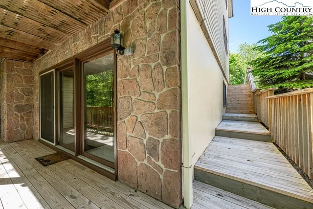 a view of a balcony with wooden floor and fence