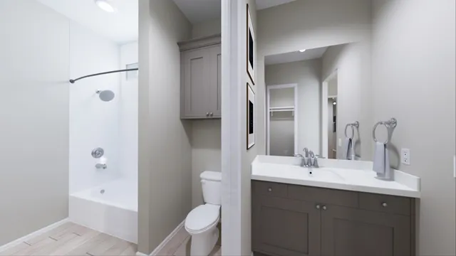a bathroom with a double vanity sink toilet mirror and bathtub