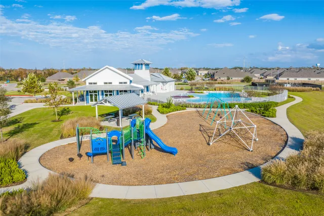swimming pool view with a seating space