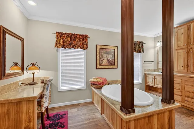 a bathroom with a tub sink and mirror