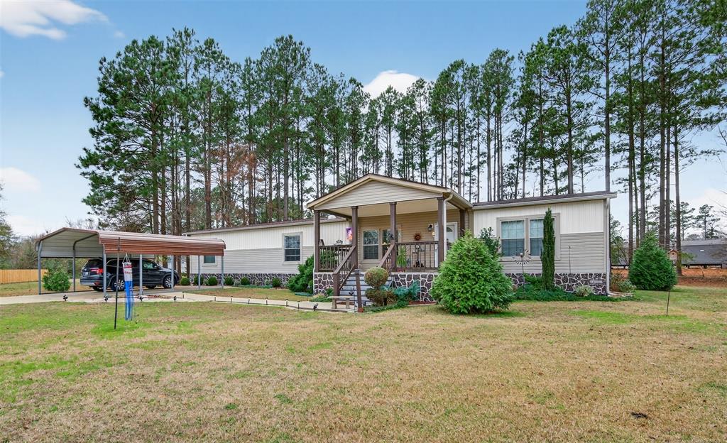 8794 Castle Dale Loop Shreveport, LA 71107 - Photo 2 of 31 Manufactured / mobile home featuring a front yard, covered porch, and a detached carport