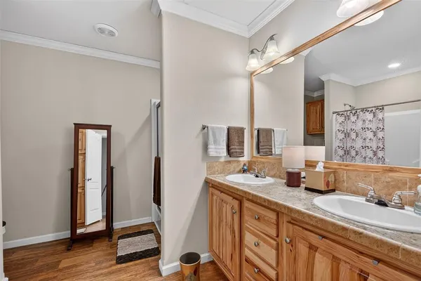 a bedroom with a bed and a dresser with bookshelf