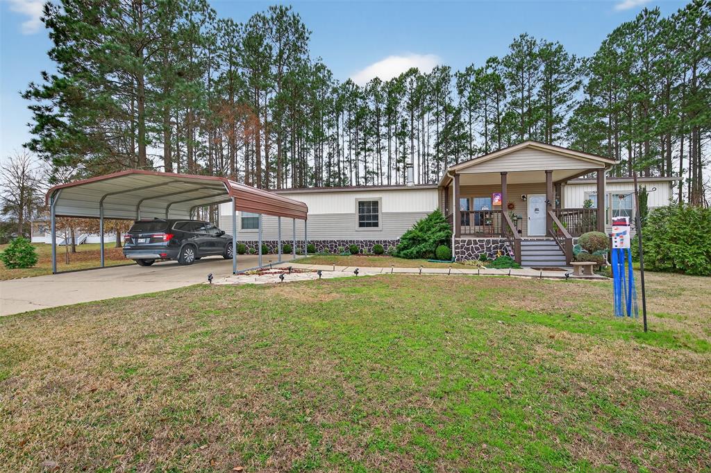 8794 Castle Dale Loop Shreveport, LA 71107 - Photo 3 of 31 Manufactured / mobile home with a porch, a front yard, a carport, and driveway