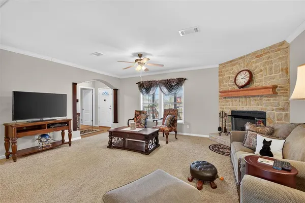 a living room with furniture a rug and a fireplace