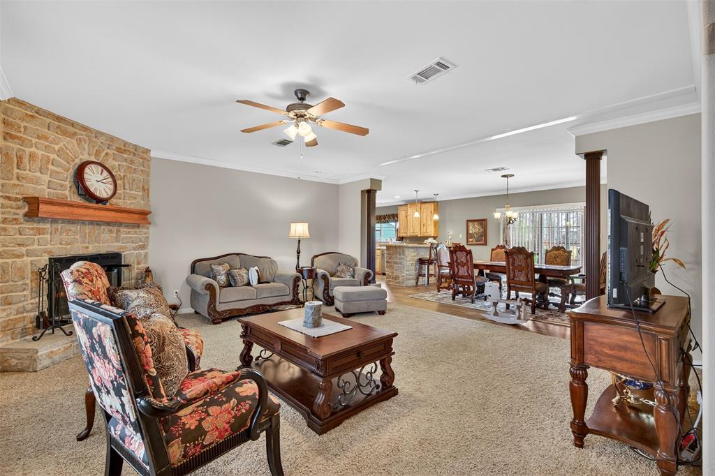 8794 Castle Dale Loop Shreveport, LA 71107 - Photo 9 of 31 Living room with ornamental molding, a chandelier, a ceiling fan, ornate columns, and carpet floors